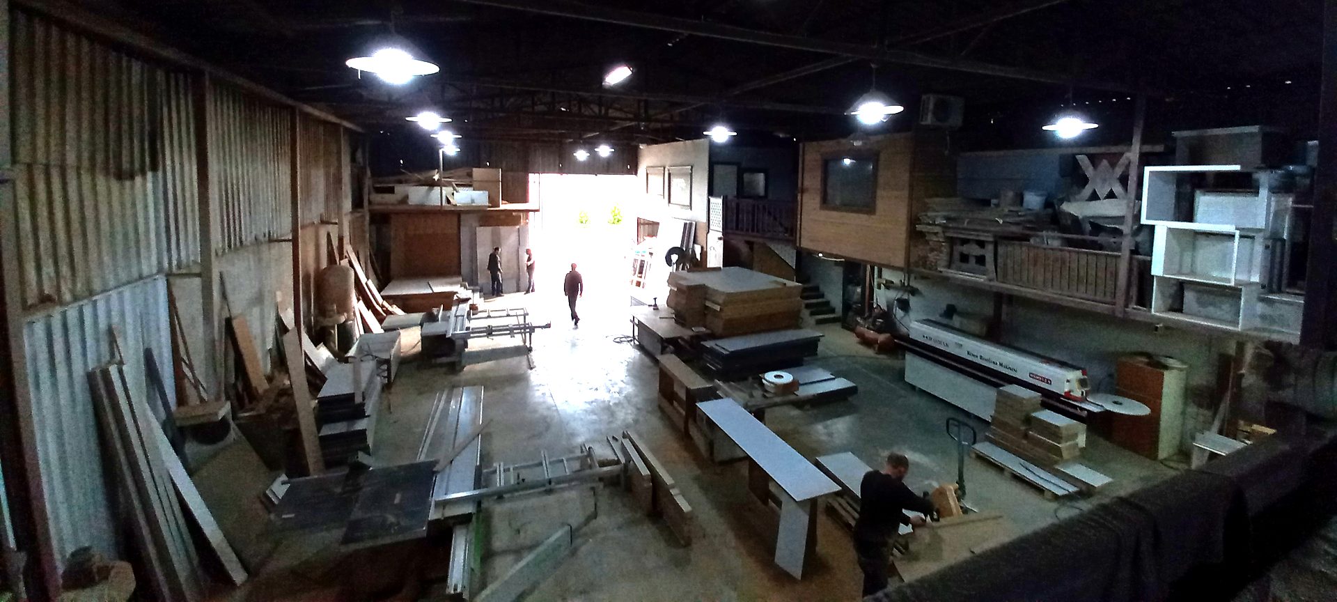 Wide view of the ReFix furniture production hall in Alanya with cabinet carcasses, board stock and machinery